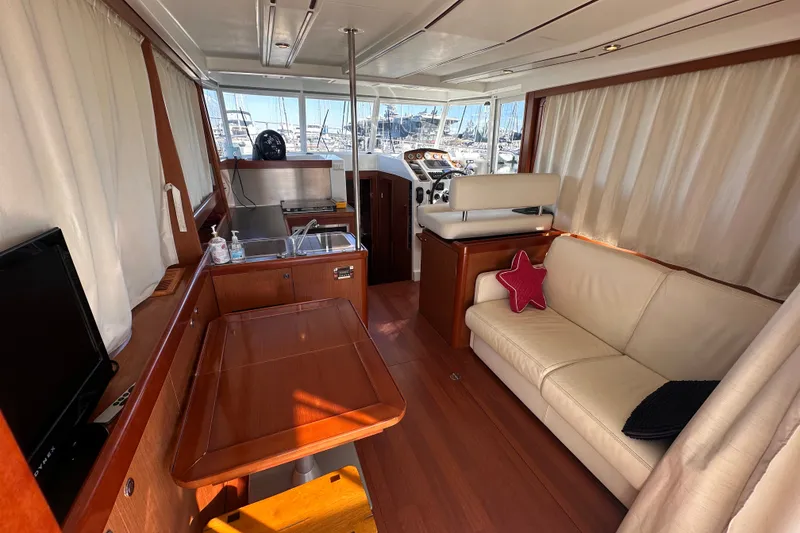 Slide: The Image of Interior of 2011 Beneteau Swift Trawler 34 with cozy seating and wooden finishes. - 32