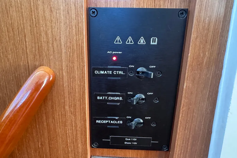 Slide: The Image of Control panel on a 2011 Beneteau Swift Trawler 34, featuring climate and power switches. - 57