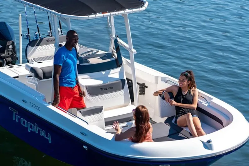 Slide: The Image of 2027 Bayliner Trophy T22CC boat with people enjoying a sunny day on the water. - 5
