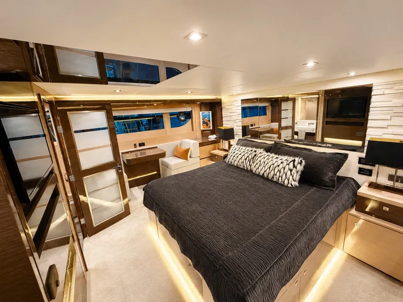 Slide: The Image of Luxurious cabin with a large bed, modern decor, and stylish lighting on a Cruisers Yachts 60 Fly. - 24
