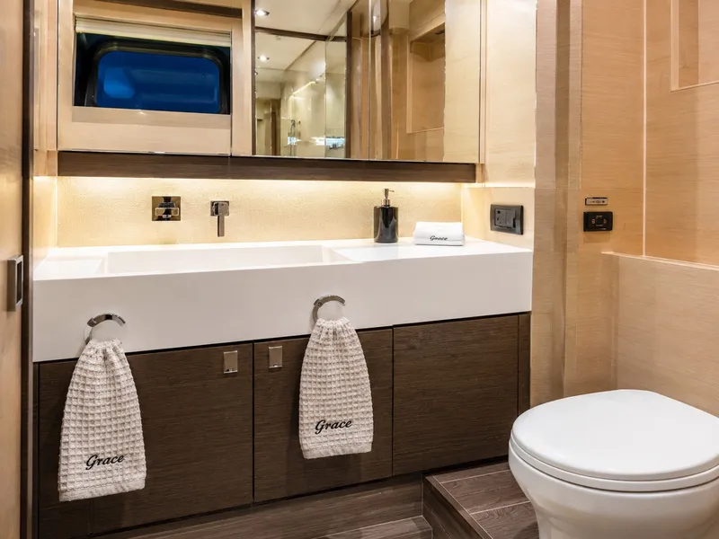 Slide: The Image of Luxurious bathroom with double sinks, modern fixtures, and sleek wood paneling on a Cruisers Yachts 60 Fly. - 32