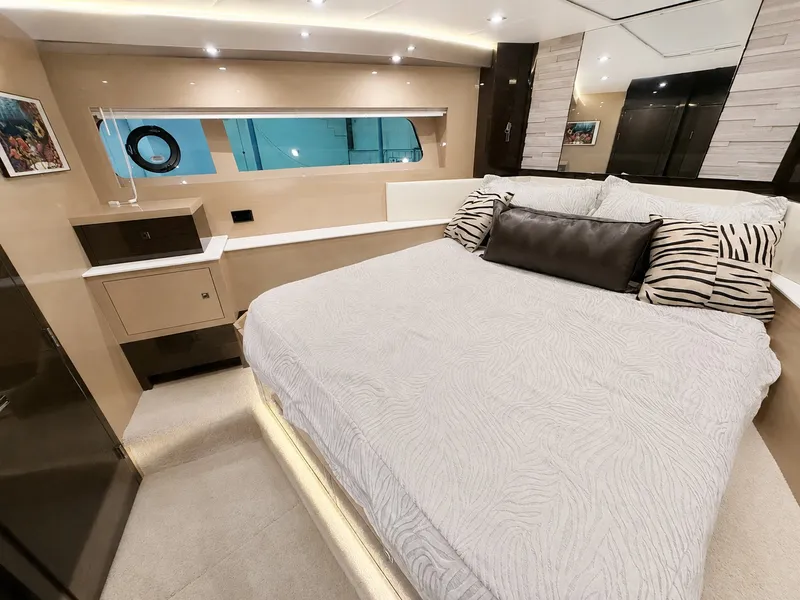 Slide: The Image of Luxurious cabin with a large bed, stylish pillows, and modern design on a Cruisers Yachts 60 Fly. - 38