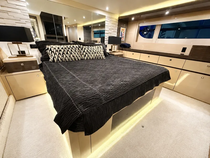 Slide: The Image of Luxurious bedroom with a large bed, modern lamps, and sleek cabinets on a yacht. - 26