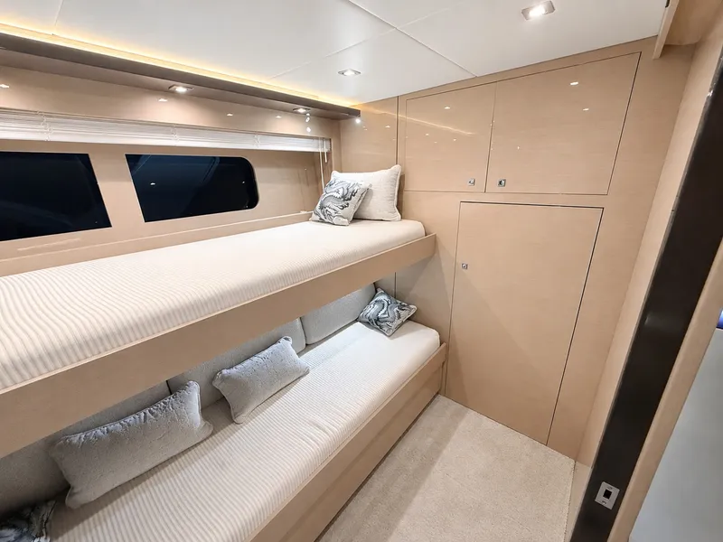 Slide: The Image of Interior of the 2019 Cruisers Yachts 60 Fly with bunk beds and sleek decor. - 42