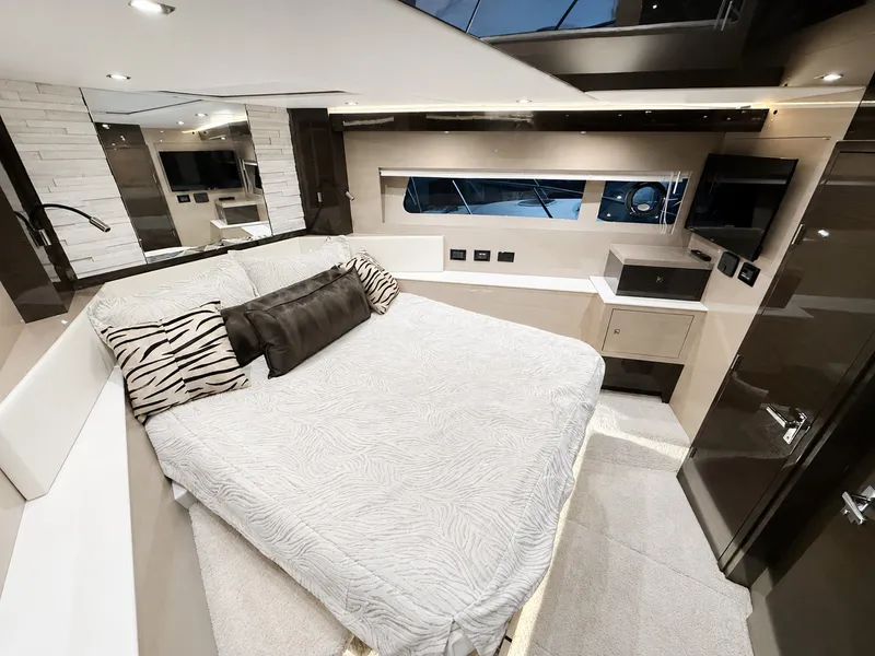 Slide: The Image of The image shows a luxurious cabin with a large bed, modern furnishings, and a window. - 37