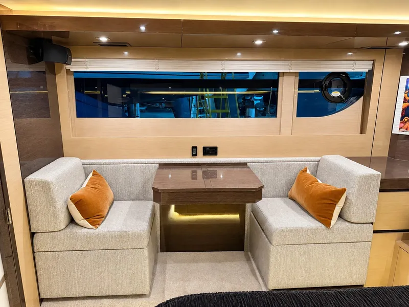 Slide: The Image of Interior of a 2019 Cruisers Yachts 60 Fly with a cozy seating area and table. - 30