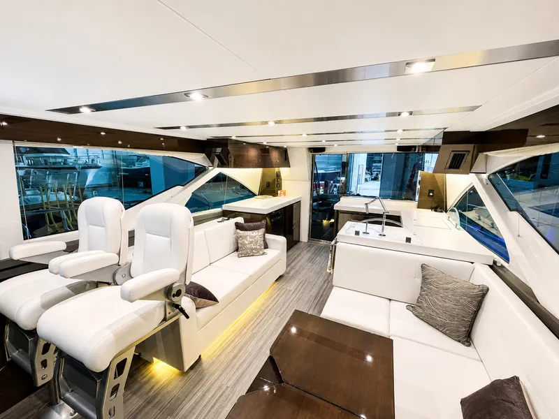 Slide: The Image of Luxurious interior of a 2019 Cruisers Yachts 60 Fly with white seating and modern furnishings. - 15