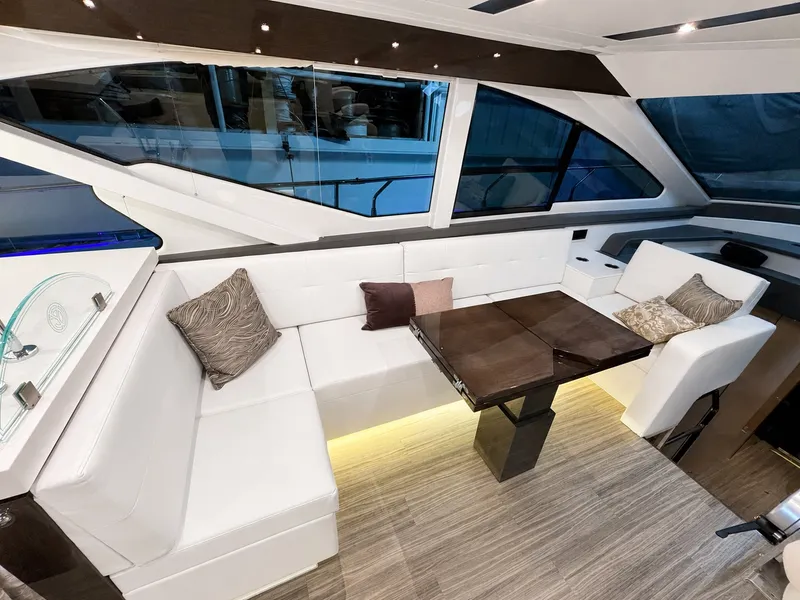 Slide: The Image of Interior of a 2019 Cruisers Yachts 60 Fly with elegant seating area and modern table. - 14