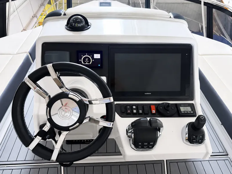 Slide: The Image of The image shows the helm of a 2019 Cruisers Yachts 60 Fly with modern instruments. - 17