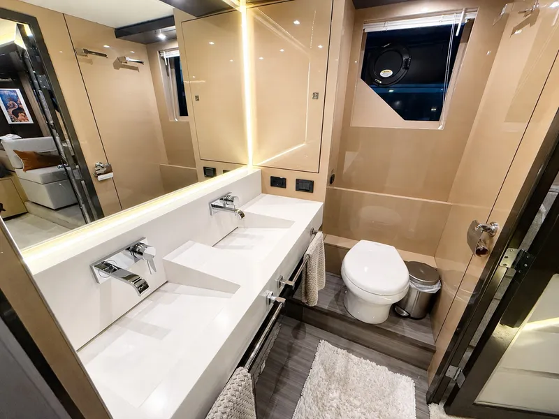 Slide: The Image of Luxurious bathroom with double sinks, toilet, and modern design on a Cruisers Yachts 60 Fly. - 31