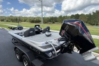 Slide: The Image of 2027 Nitro Z20 XL boat on trailer, parked outdoors under a cloudy sky. - 7