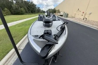 Slide: The Image of 2027 Nitro Z20 XL boat on paved road near grassy area and building. - 4