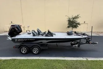 Slide: The Image of 2027 Nitro Z20 XL boat on trailer, parked outdoors, side view. - 1