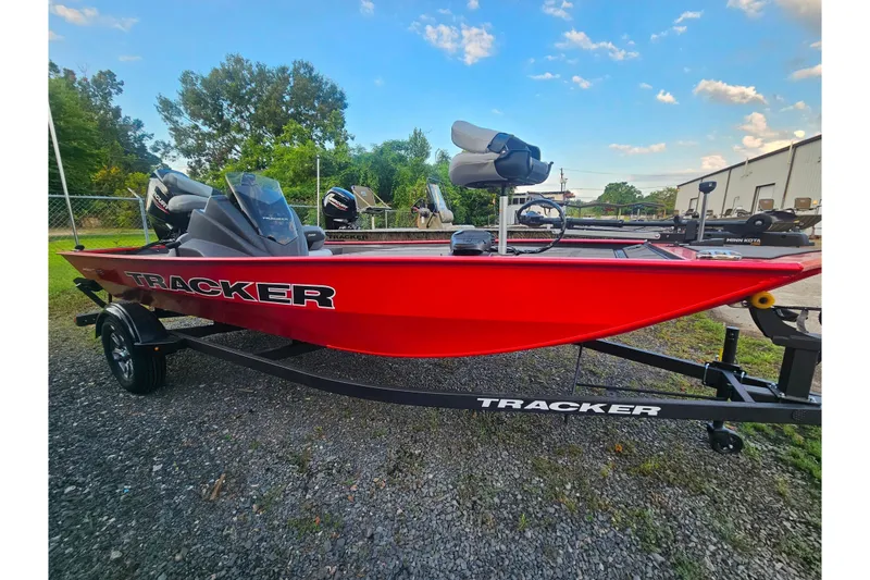 The Image of 2027 Tracker Pro 170 boat in vibrant red, parked outdoors on a trailer. - 0