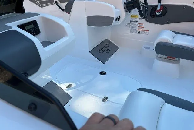 Slide: The Image of Interior of a 2027 Tahoe T21 boat featuring sleek white and gray seating. - 100