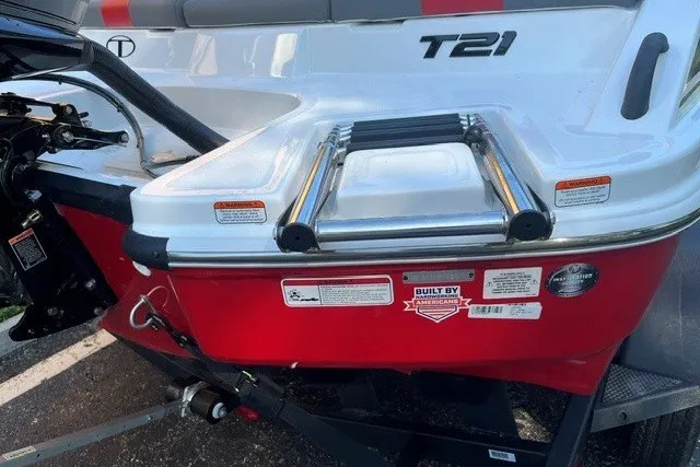 Slide: The Image of 2027 Tahoe T21 boat rear view with ladder and branding labels. - 12
