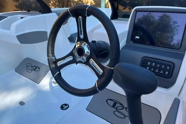Slide: The Image of Steering wheel and dashboard of 2027 Tahoe T21 boat, featuring modern controls and design. - 6