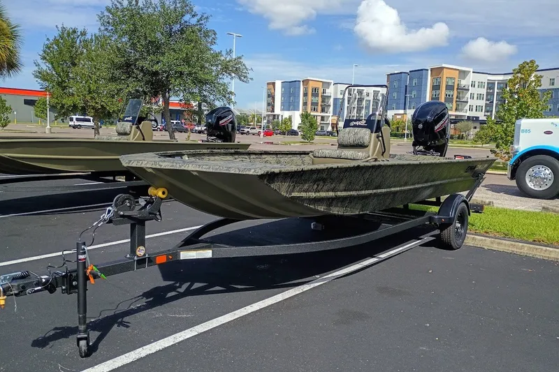The Image of 2027 Tracker Grizzly 1860 CC boat on trailer in parking lot. - 0