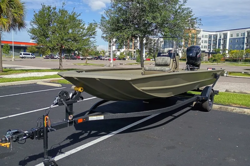 The Image of 2027 Tracker Grizzly 1860 CC boat on trailer in parking lot, sunny day. - 0