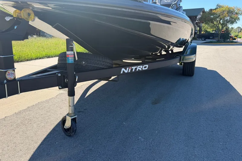 Slide: The Image of Trailer of a 2027 Nitro Z18 XL Pro boat parked on a sunny street. - 13