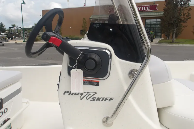 Slide: The Image of 2027 Mako Pro Skiff 17 CC boat steering console with windshield and control panel. - 5