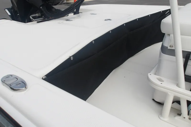 Slide: The Image of 2027 Mako Pro Skiff 17 CC boat interior with storage compartment and seating. - 7