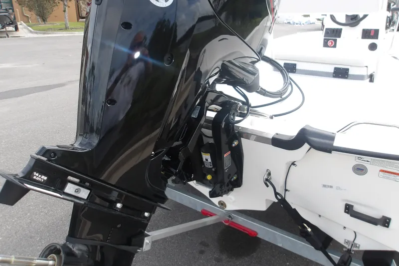 Slide: The Image of 2027 Mako Pro Skiff 17 CC boat with a powerful outboard motor on a trailer. - 10