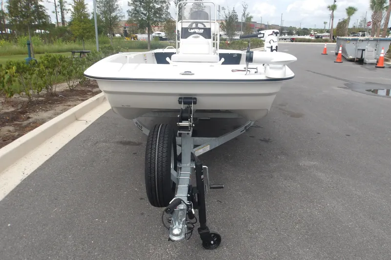 The Image of 2027 Mako Pro Skiff 17 CC boat on trailer, parked on a paved road. - 0