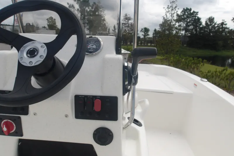 Slide: The Image of Steering console of 2027 Mako Pro Skiff 17 CC boat with control panel. - 9