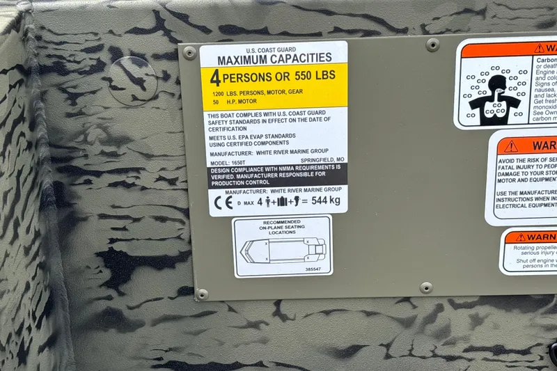 Slide: The Image of Tracker Grizzly 1650 T Prairie Wings Edition 2027 capacity label, safety warnings, and specifications. - 18