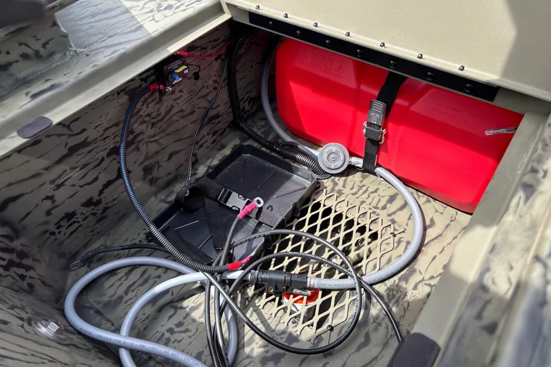 Slide: The Image of Interior view of 2027 Tracker Grizzly 1650 T Prairie Wings Edition boat wiring and fuel tank. - 17