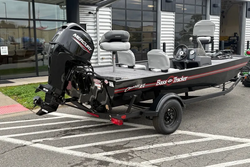 The Image of 2027 Tracker Bass Tracker Classic XL boat with Mercury engine on trailer outside dealership. - 0