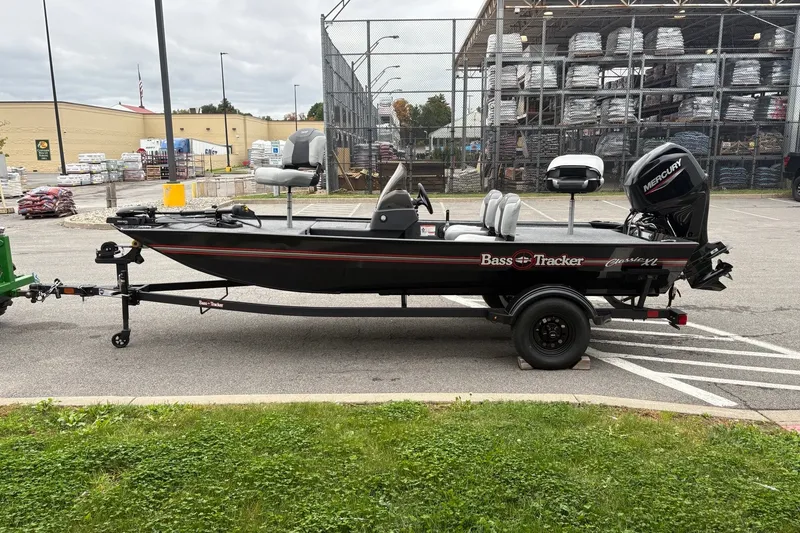The Image of 2027 Tracker Bass Tracker Classic XL boat on trailer in parking lot. - 0