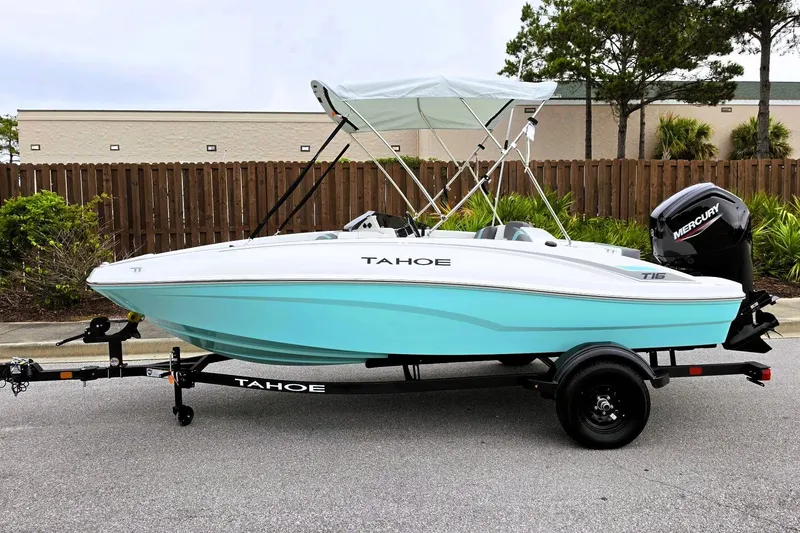 Slide: The Image of 2027 Tahoe T16 boat with canopy on trailer, featuring sleek design and Mercury outboard motor. - 9