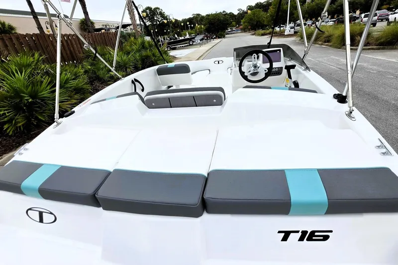 Slide: The Image of 2027 Tahoe T16 boat interior with modern seating and steering wheel. - 12
