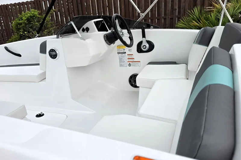 Slide: The Image of Interior of a 2027 Tahoe T16 boat with modern seating and steering wheel. - 17