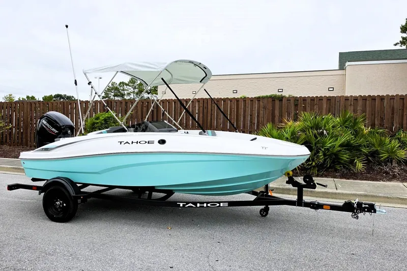 Slide: The Image of 2027 Tahoe T16 boat with canopy on trailer, parked outdoors. - 5
