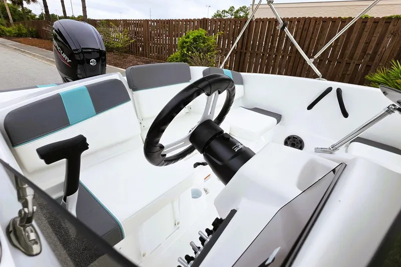 Slide: The Image of 2027 Tahoe T16 boat interior with steering wheel and seating, featuring modern design elements. - 16