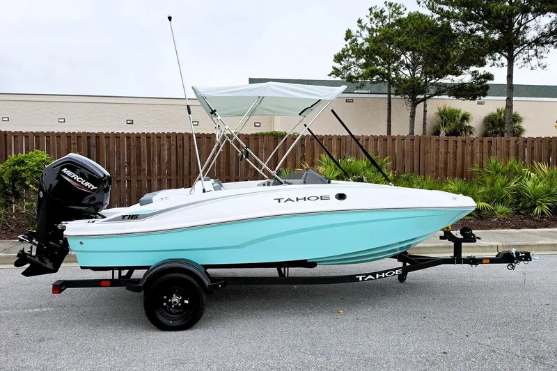 The Image of 2027 Tahoe T16 boat with Mercury engine on trailer, parked outdoors. - 0