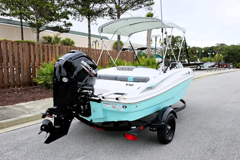 Slide: The Image of 2027 Tahoe T16 boat with Mercury engine on trailer, parked outdoors. - 3