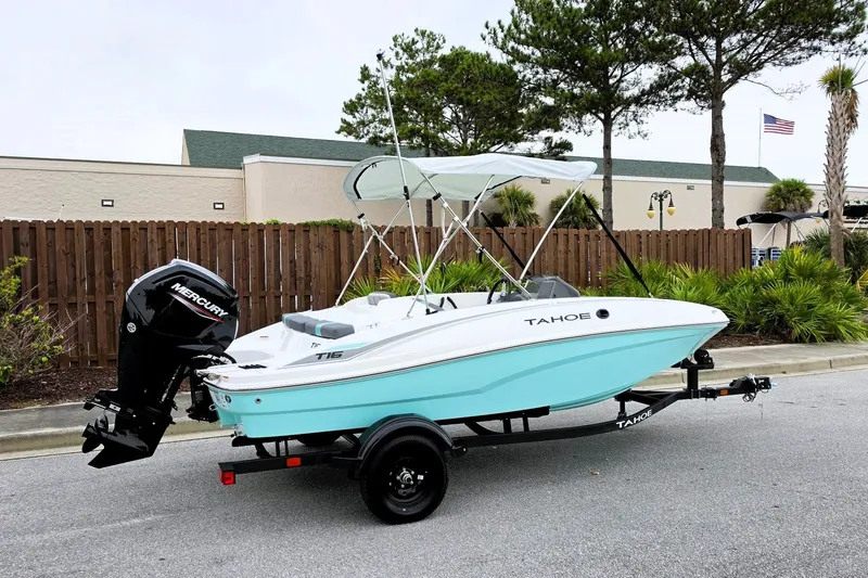 Slide: The Image of 2027 Tahoe T16 boat with Mercury engine on trailer, parked outdoors. - 1