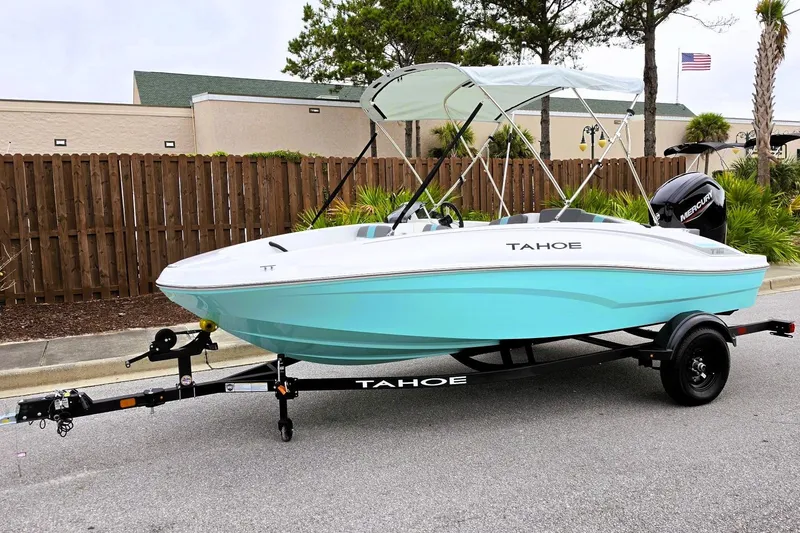Slide: The Image of 2027 Tahoe T16 boat with canopy on trailer, parked on street. - 10