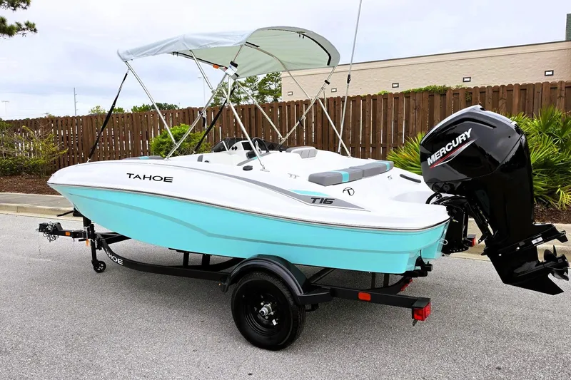 Slide: The Image of 2027 Tahoe T16 boat with Mercury engine on trailer, parked outdoors. - 11