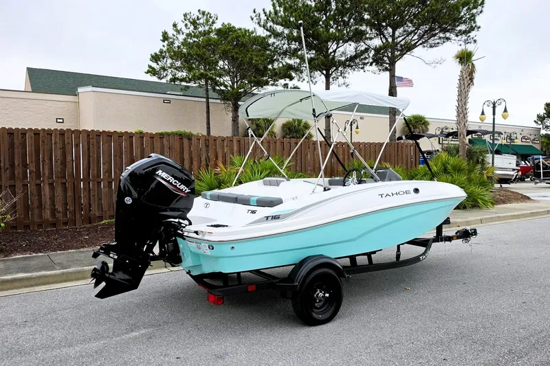 Slide: The Image of 2027 Tahoe T16 boat with Mercury engine on trailer, parked outdoors. - 2