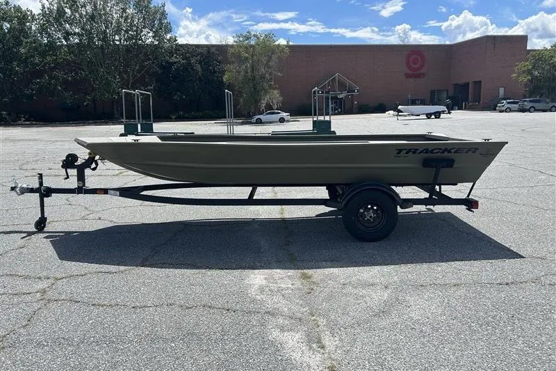 The Image of 2027 Tracker Grizzly 1754 Utility boat on trailer in parking lot. - 0