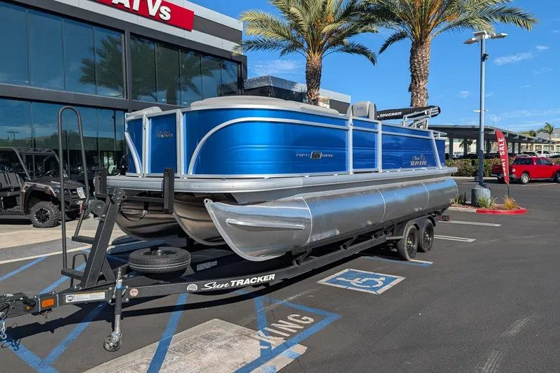 The Image of 2026 Sun Tracker Party Barge 22 RF XP3 pontoon boat on trailer in parking lot. - 0