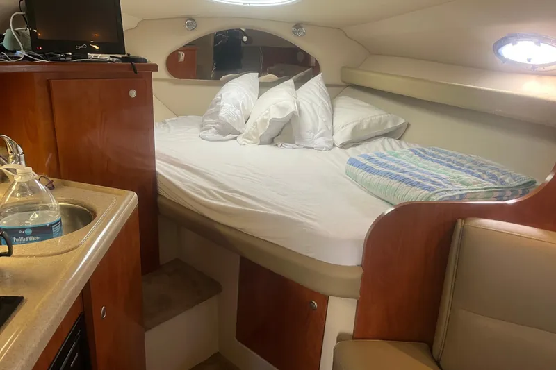 Slide: The Image of Cozy cabin interior of 2007 Cruisers Yachts 280 CXi Express with bed and kitchenette. - 2