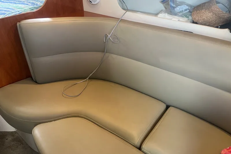 Slide: The Image of 2007 Cruisers Yachts 280 CXi Express interior seating with beige upholstery and wooden accents. - 3
