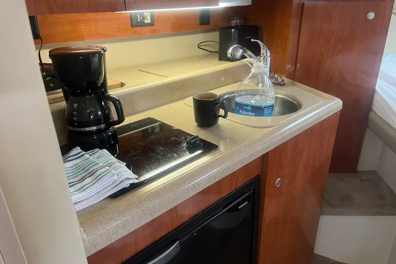 Slide: The Image of 2007 Cruisers Yachts 280 CXi Express cabin kitchen with coffee maker and sink. - 5