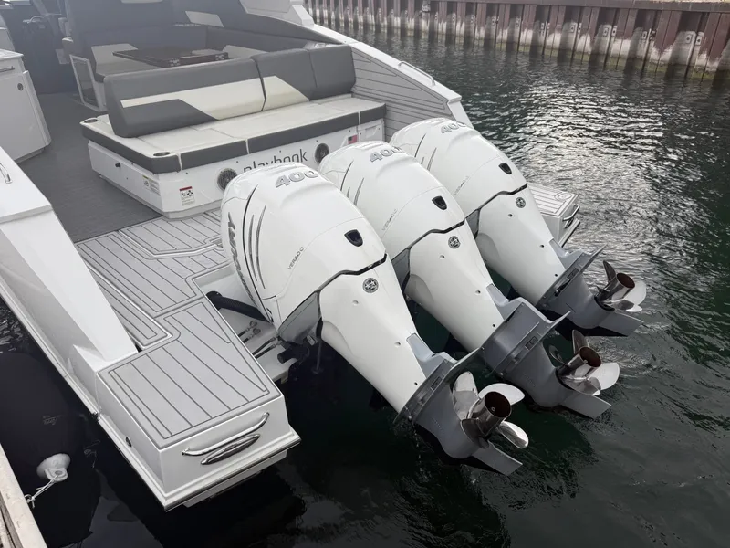 Slide: The Image of The image shows a 2021 Cruisers Yachts 42 GLS OB boat with three outboard engines. - 49